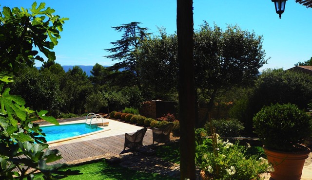 A cozy home surrounded by nature, with a private pool and tennis court