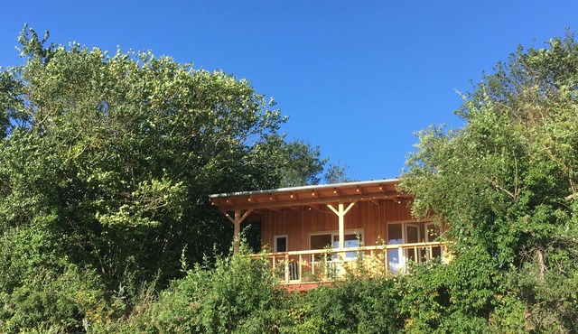 Cozy wooden cabin with a covered terrace and a panoramic view
